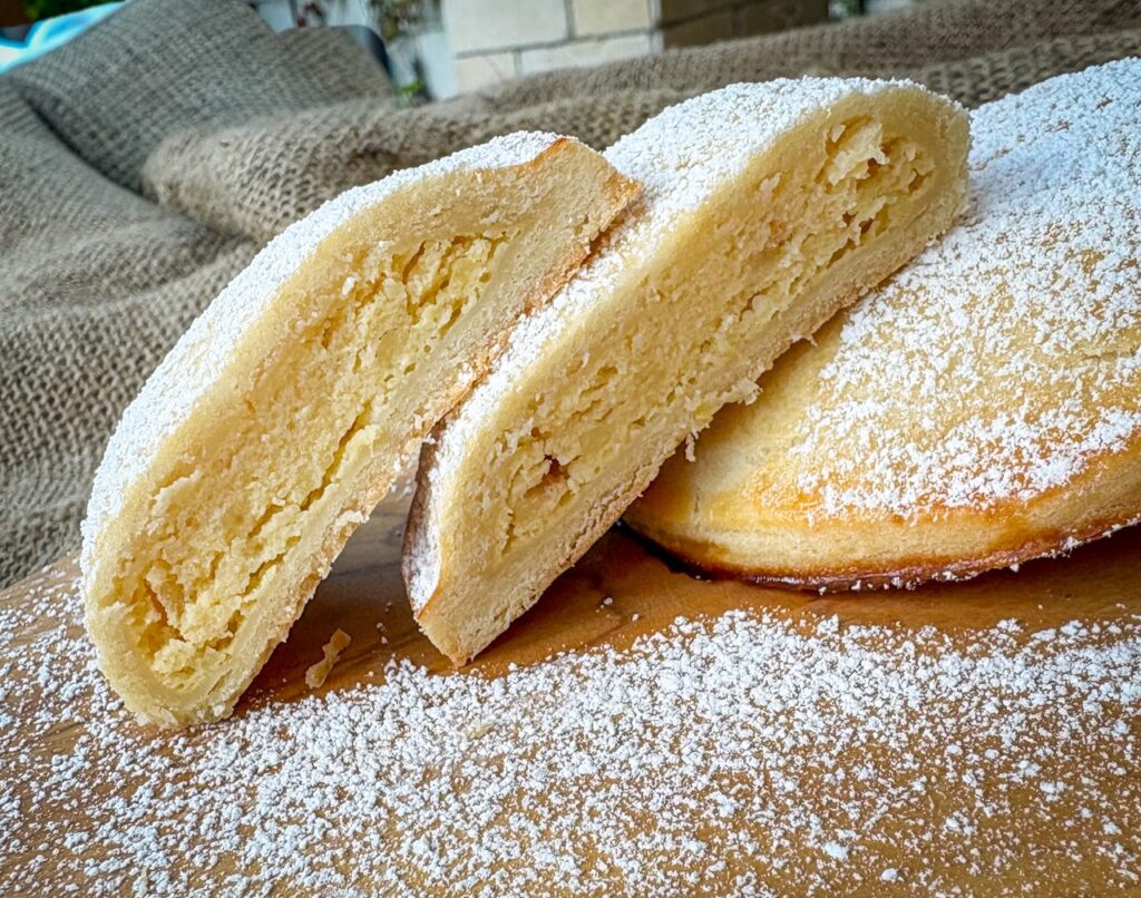 pastry with powdered sugar cut open